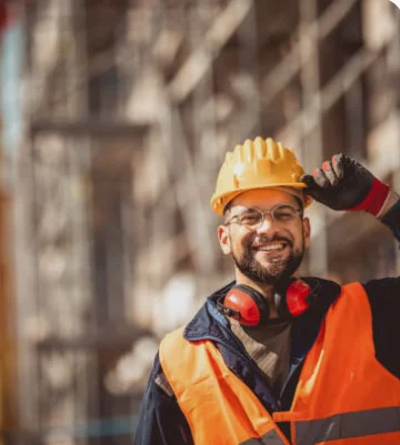 Construction site worker wearing safety equipment during commercial building works